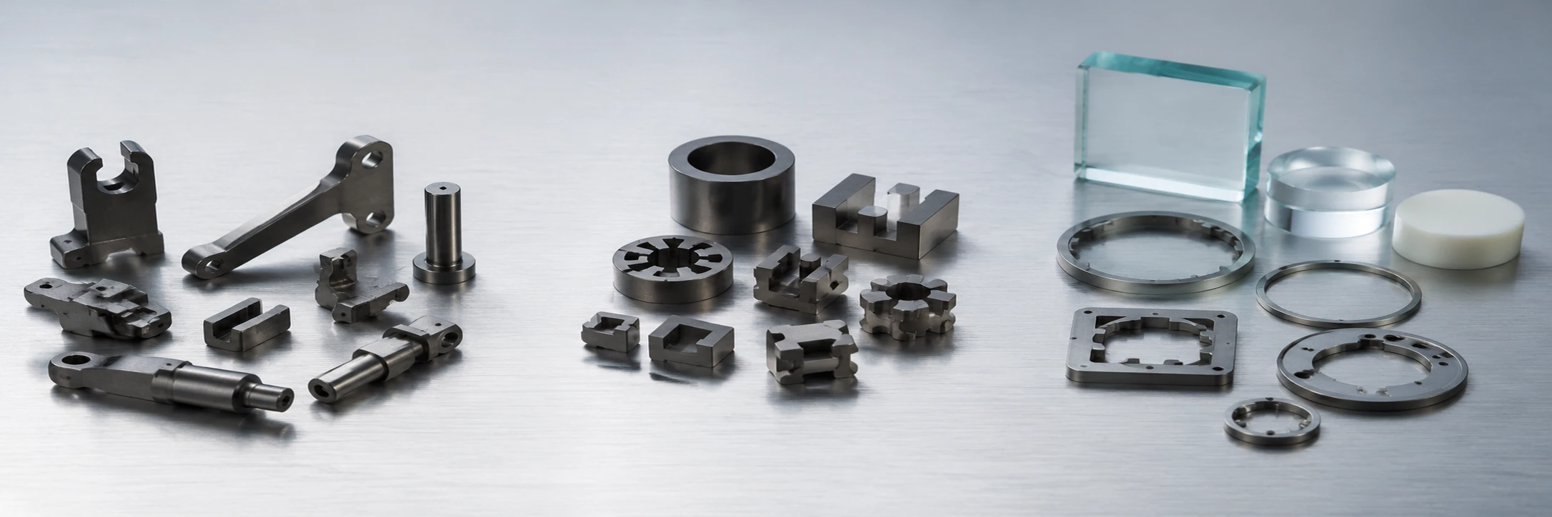 Three groups of small precision MIM parts representing structural, soft-magnetic and controlled-expansion iron–nickel alloy routes
